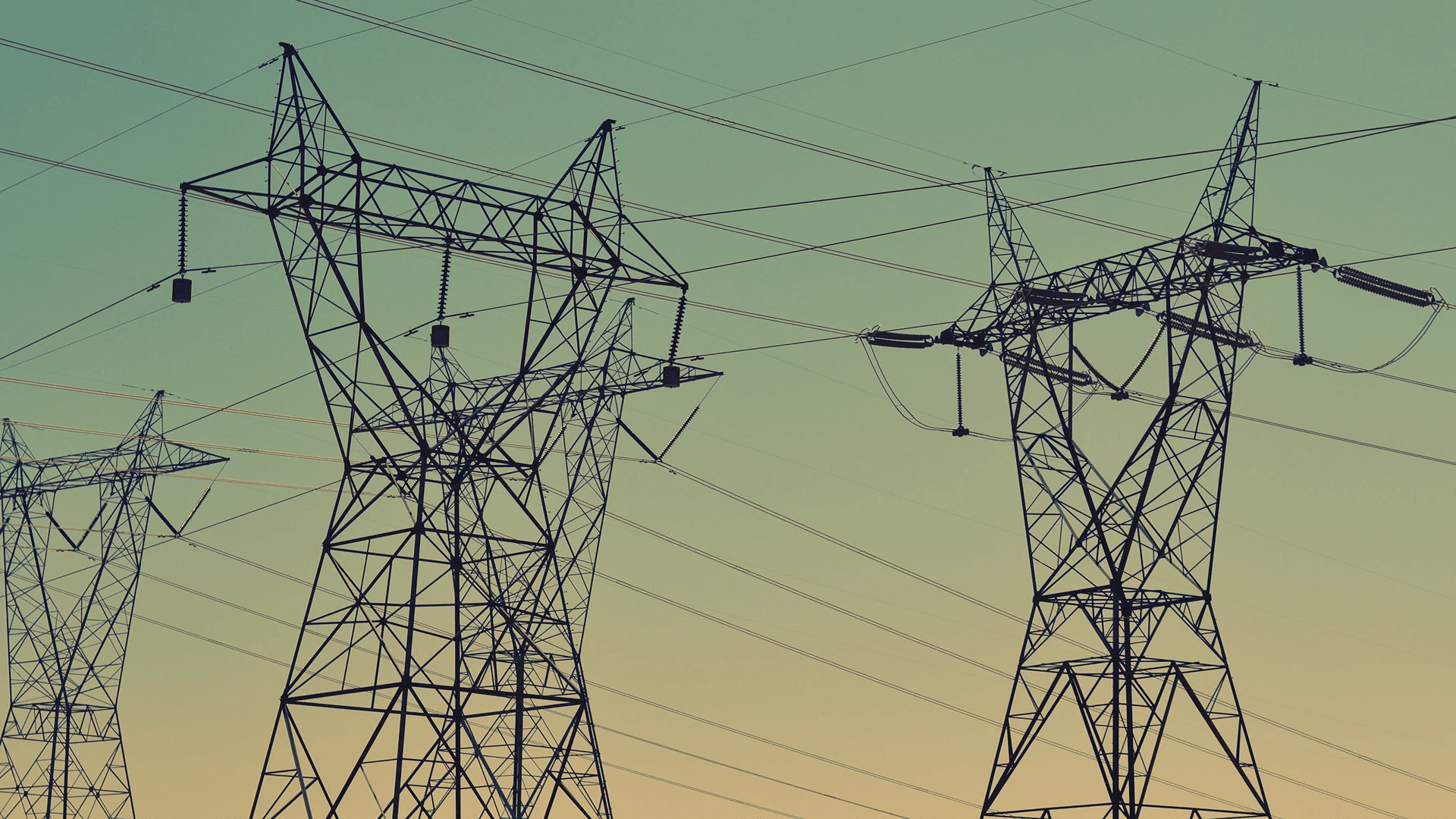 High-voltage transmission towers at dusk
